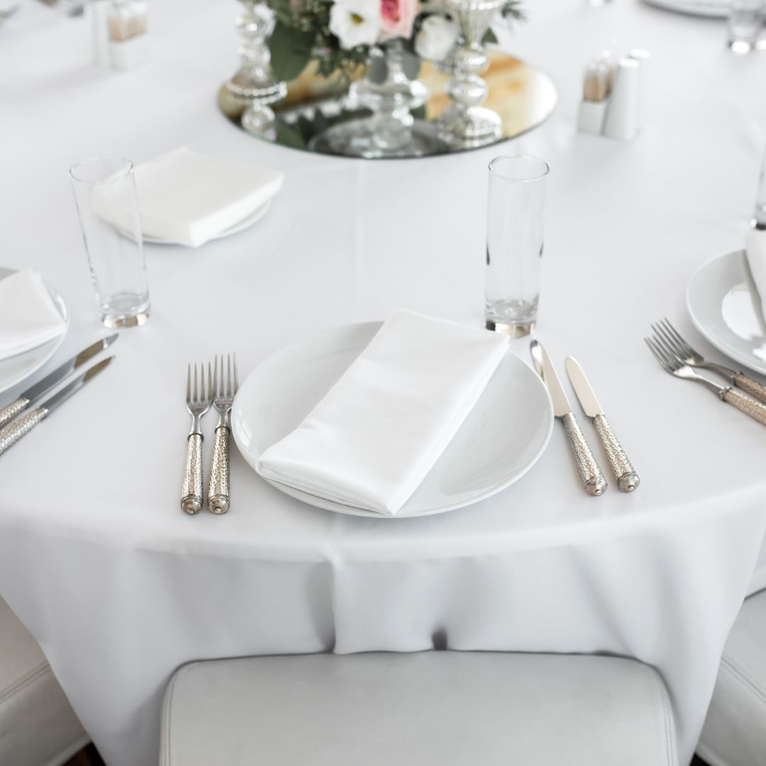 a table set with white linens