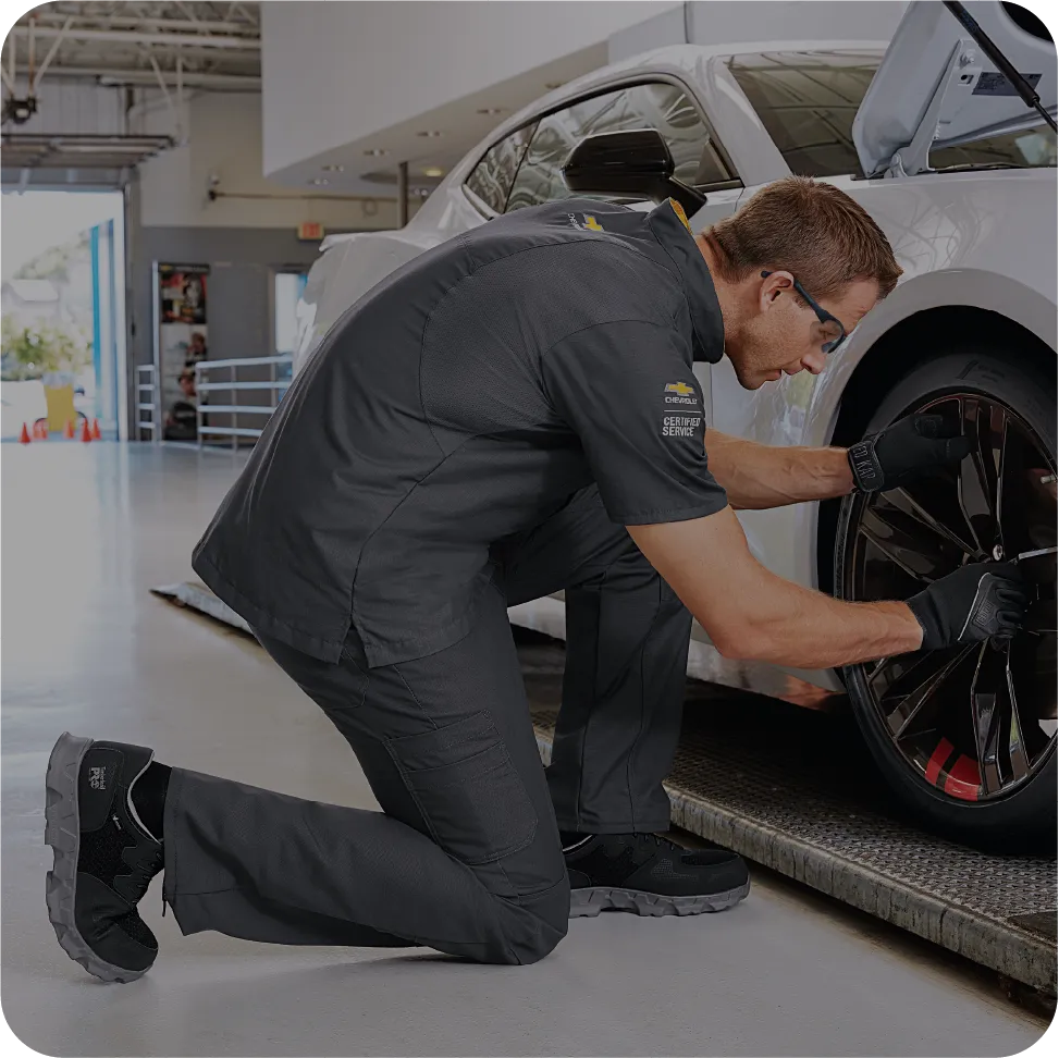 Man in Mechanic Uniform working on a car